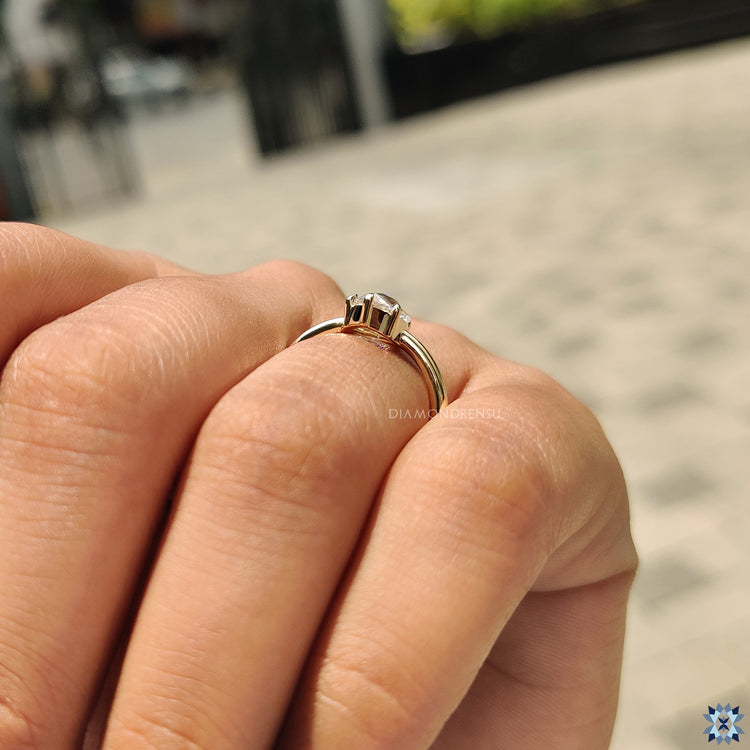 Handmade jewelry including a solitaire moissanite engagement ring.
