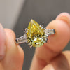 Pear three stone engagement ring with tapered baguette side stones.
