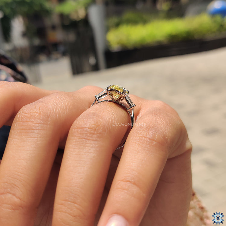 Pear cut Moissanite ring with double claw prongs and baguette accents.
