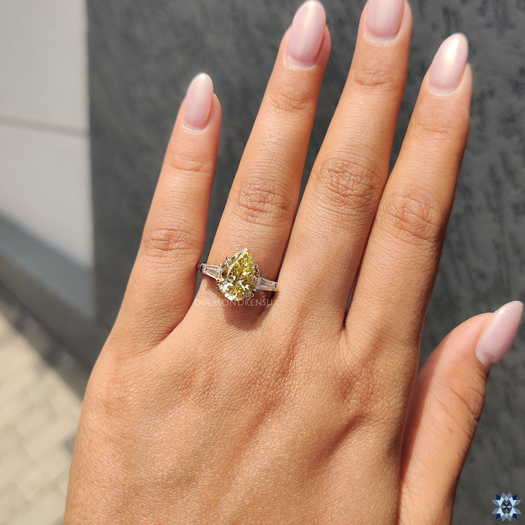 Custom Moissanite engagement ring with tapered side diamonds.
