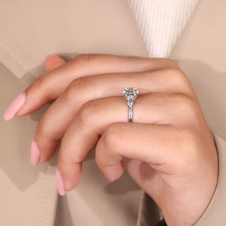 Lab-grown diamond three stone ring with pear side stones.
