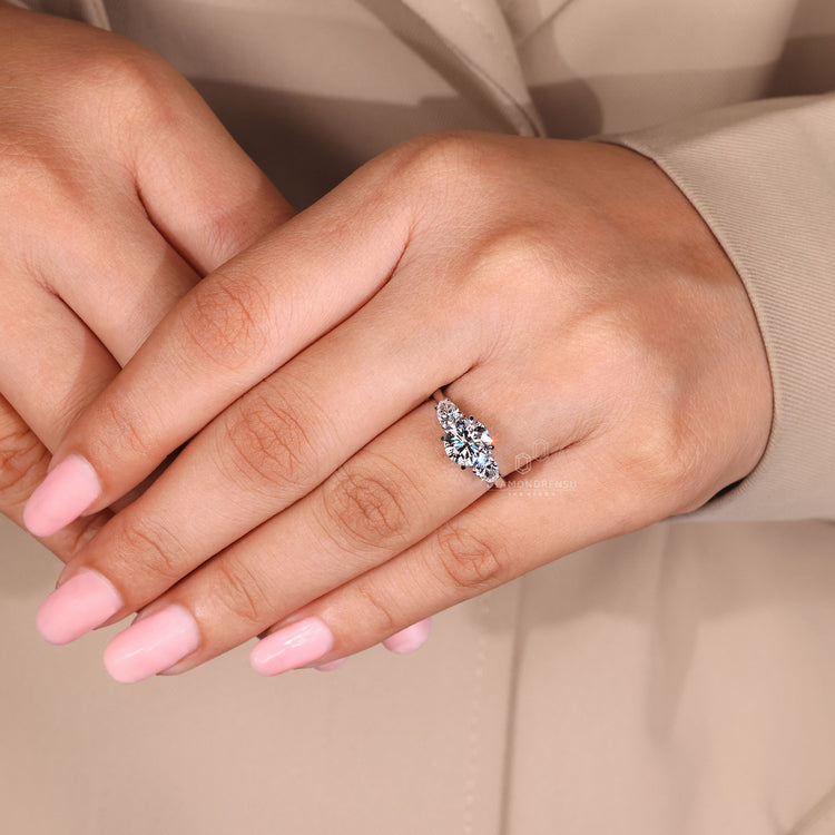 Handmade three stone diamond engagement ring with pear side stones.
