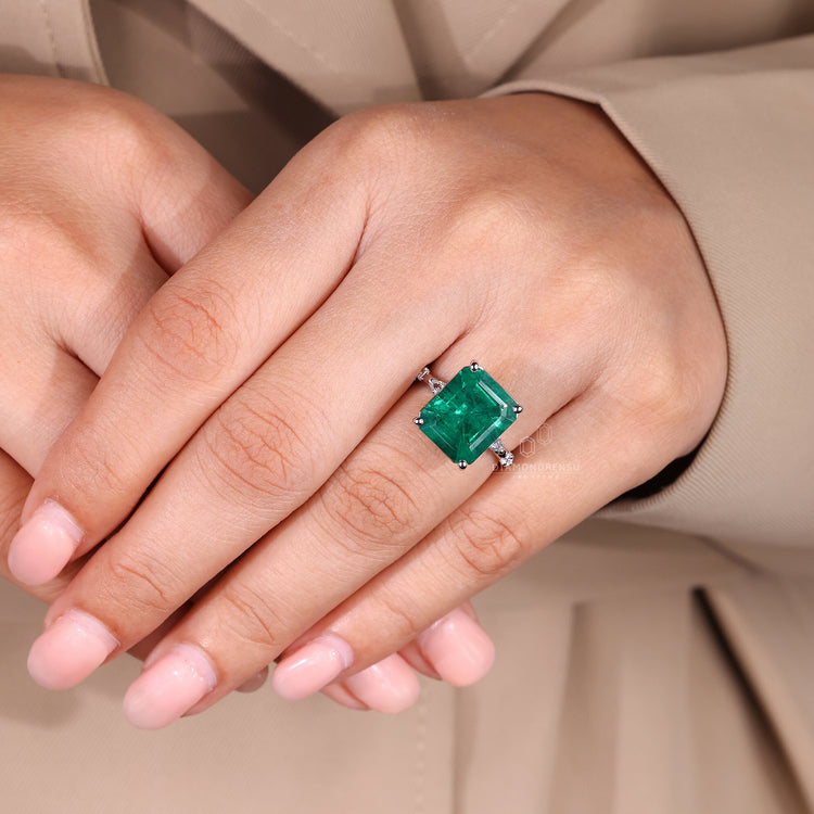 Marquise and round cut side stone emerald ring.
