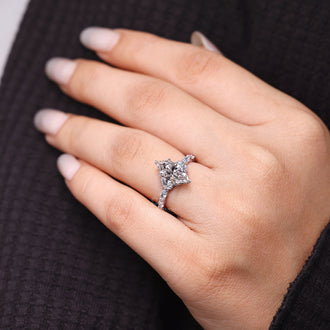 Shared prong ring with marquise cut diamonds in handmade jewelry.
