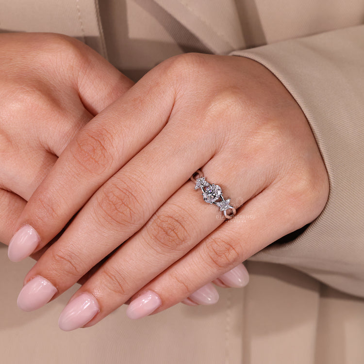 Diamondrensu engagement ring with white gold band and marquise accents.
