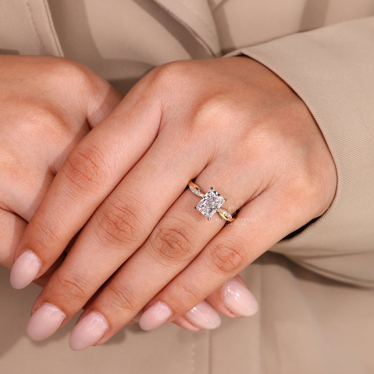 Custom engagement ring with radiant cut diamond and twisted shank design.
