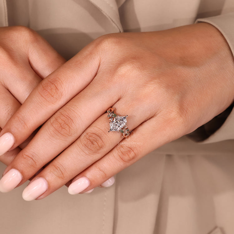 Rose gold engagement ring featuring moss agate and marquise accents.

