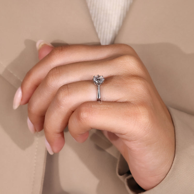 Diamondrensu ring featuring a Portuguese cut diamond in a solitaire setting.
