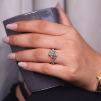 Hidden halo engagement ring with round cut side stone.
