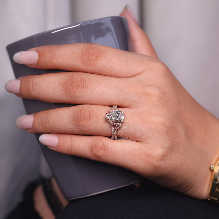 Hidden halo engagement ring with round cut side stone.
