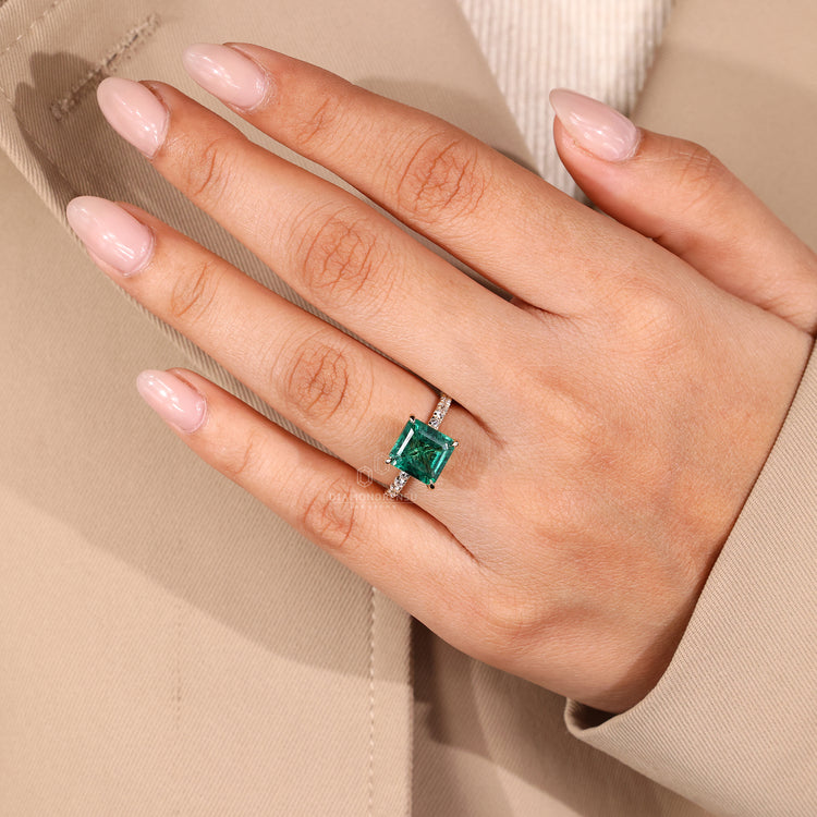 Yellow gold emerald gemstone engagement ring.
