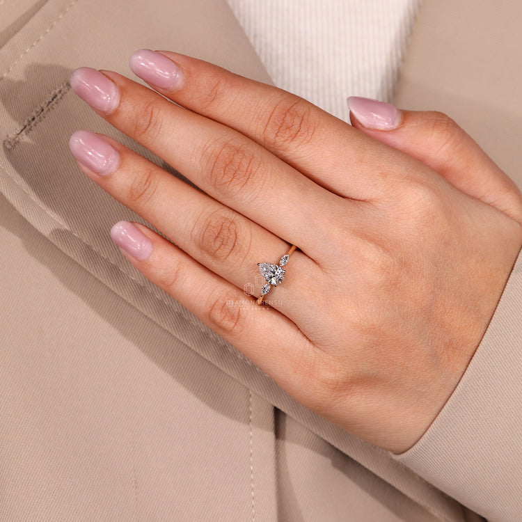 Custom diamond ring with three stone pear center diamond design.
