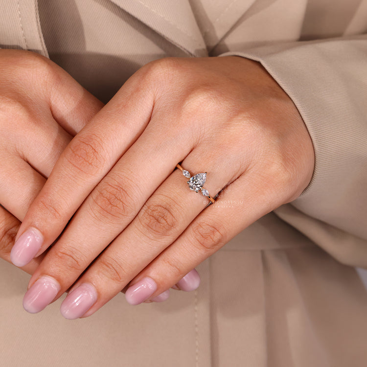 Lab Grown Diamond three stone ring with pear center diamond in yellow gold.
