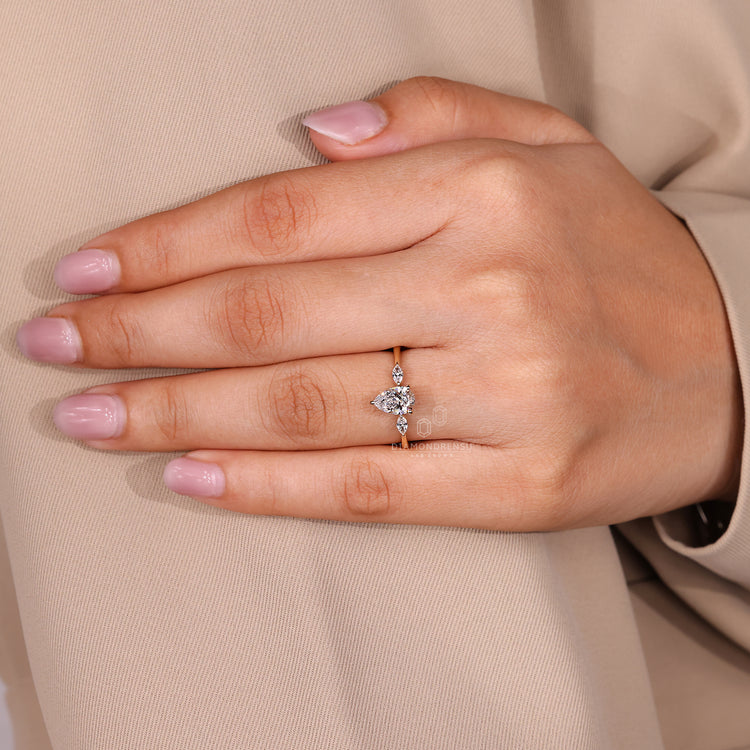 Handmade jewelry ring with three stone pear center diamond and prong setting.
