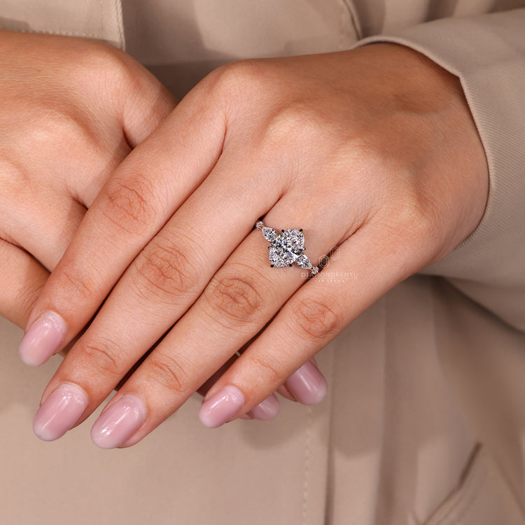Custom diamond ring with oval cut five stone design in white gold.
