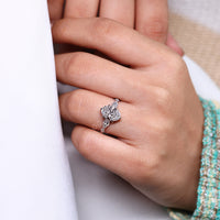 Pear and round side diamond ring with oval cut center stone.
