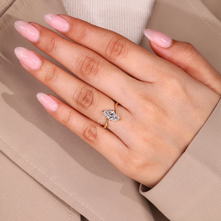 Solitaire setting marquise diamond ring with compass prongs setting.