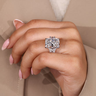 Custom diamond ring with radiant cut and trapezoid side stone.
