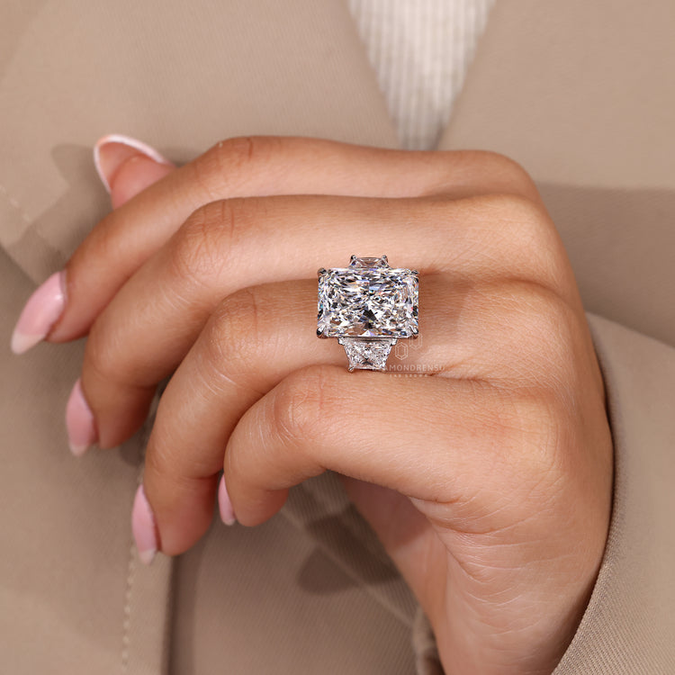 Custom diamond ring with radiant cut and trapezoid side stone.
