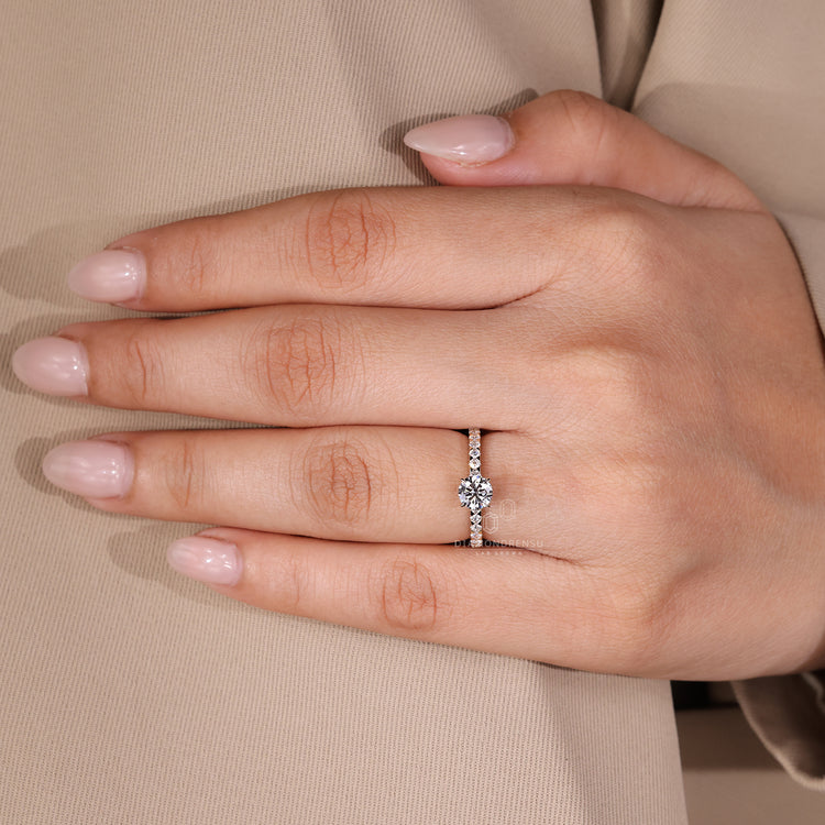 Lab grown diamond round cut ring with pave design and yellow gold band.
