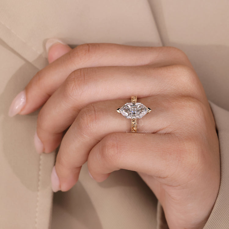 Yellow gold diamond ring with a detailed milgrain pattern and handmade touch.
