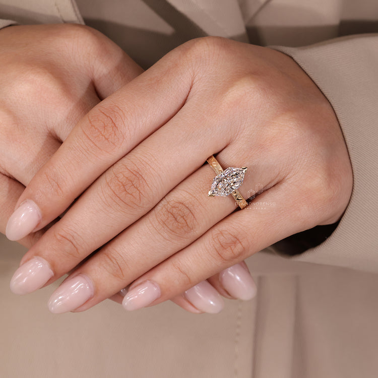 Handcrafted marquise cut diamond ring featuring 2 V shaped detailing.
