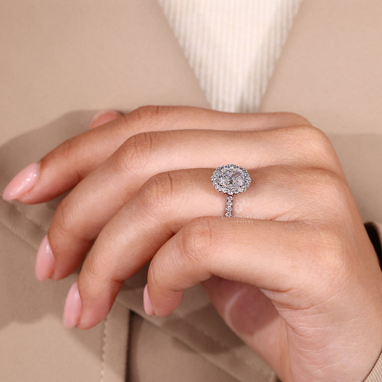 Handmade jewelry featuring round cut diamonds in halo and pave design.
