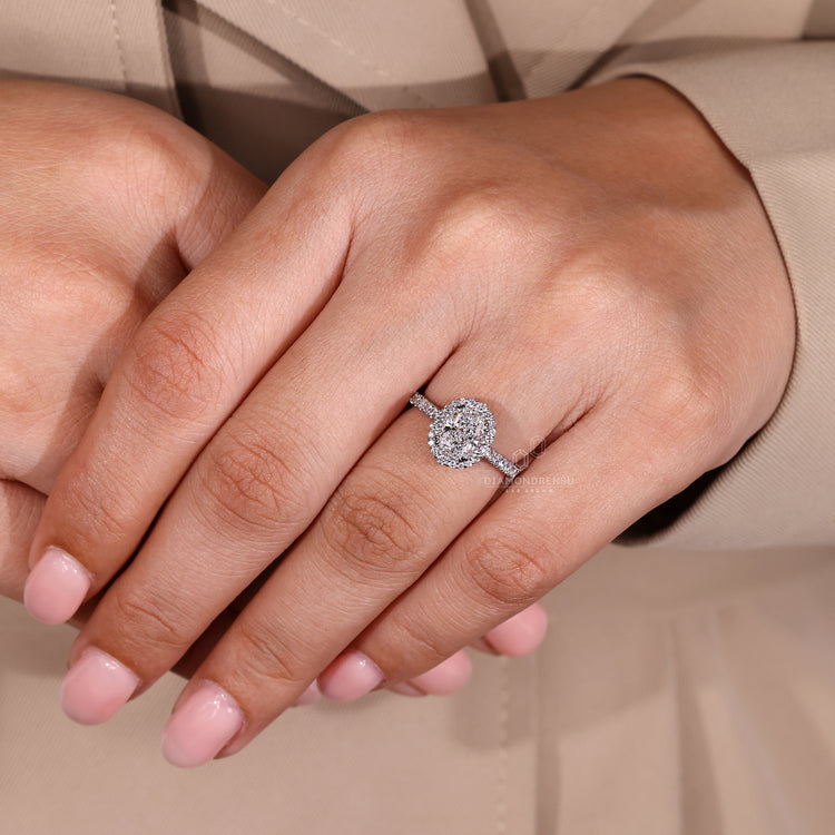 White gold engagement ring with double claw prong and halo diamond center.

