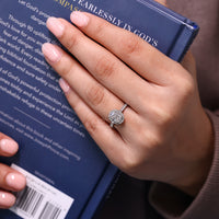 Milgrain setting ring featuring cathedral design and round cut pave band.
