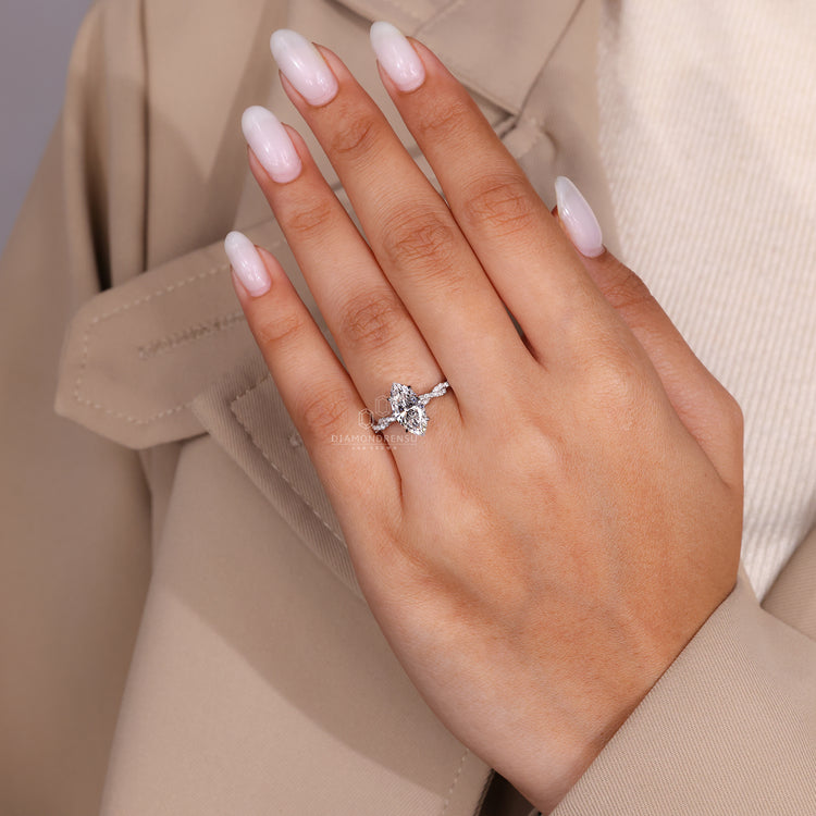 Hidden halo engagement ring with center stone surrounded by subtle accent diamonds.
