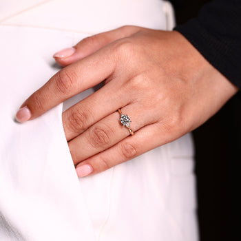 Round side stone ring crafted in yellow gold with 4 prong setting.
