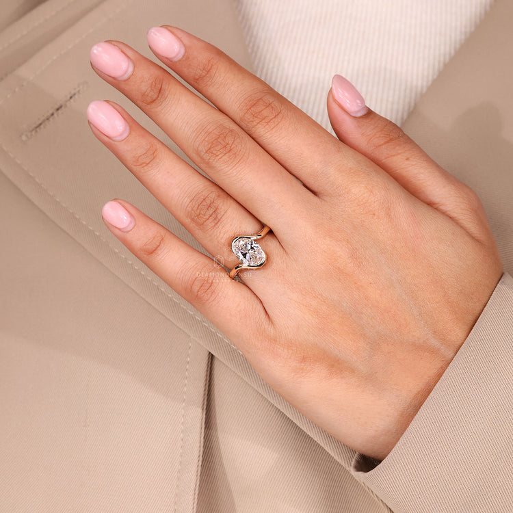 Buy engagement ring oval cut diamond with half bezel setting.
