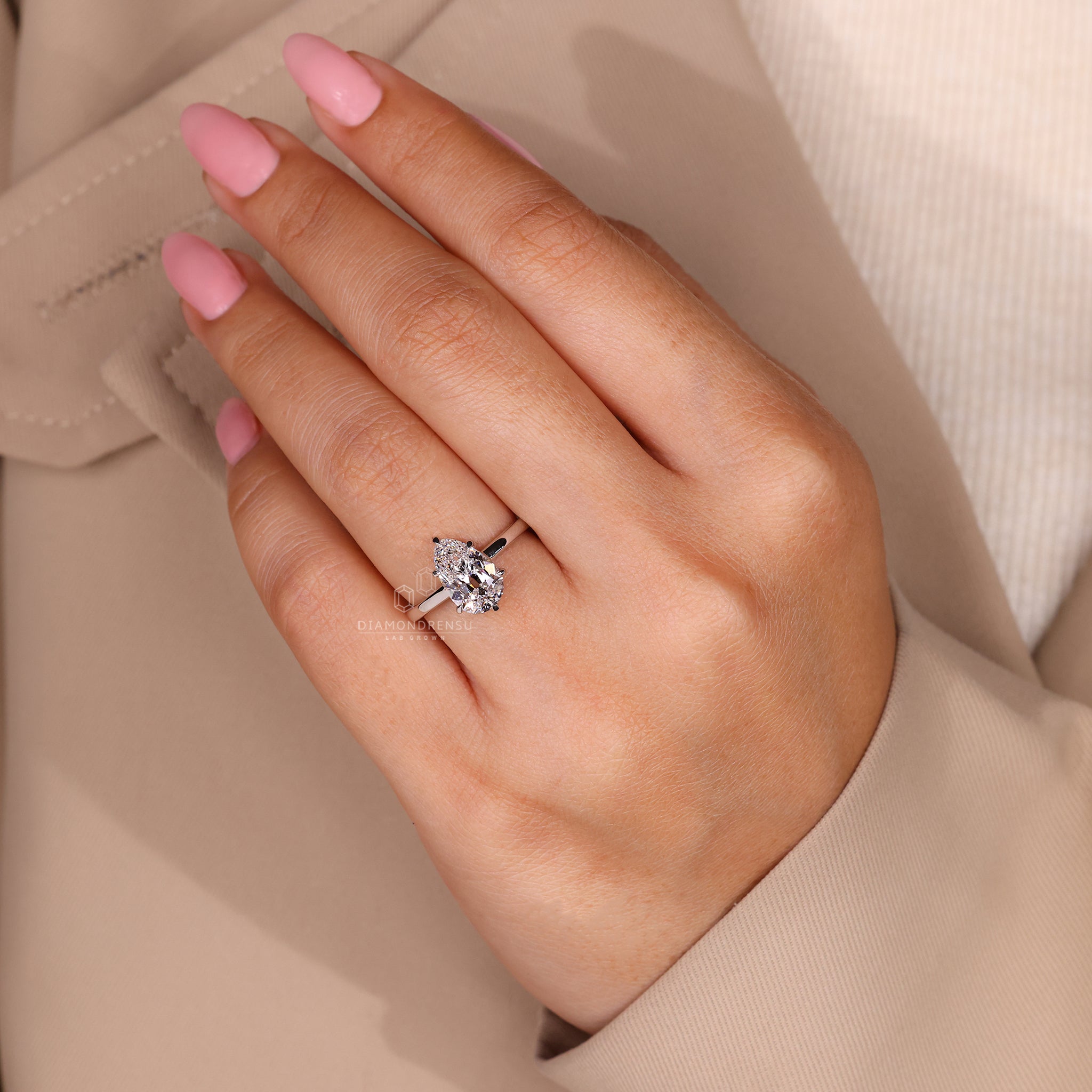 Lab grown diamond pear solitaire engagement ring.
