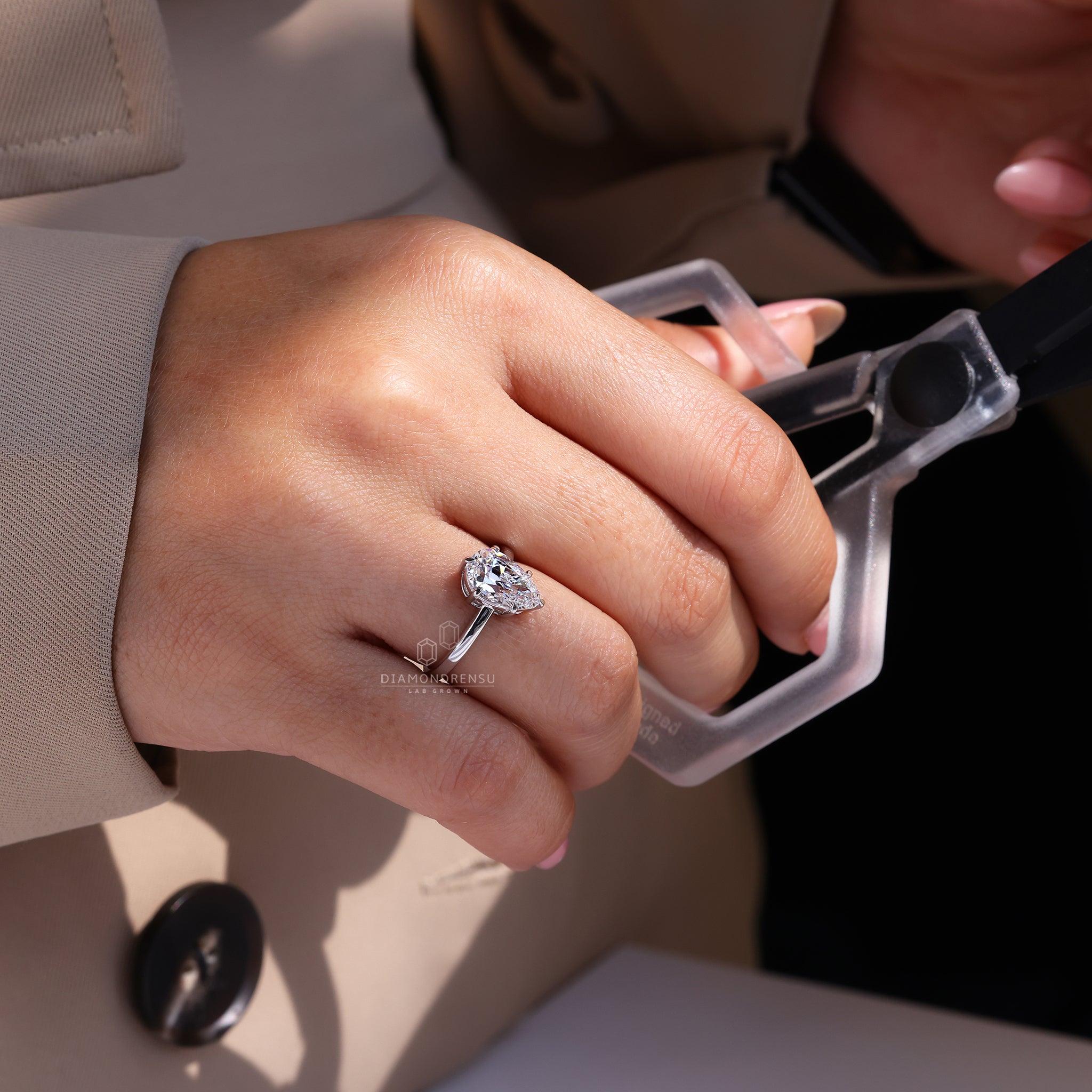 Diamondrensu pear cut solitaire engagement ring.
