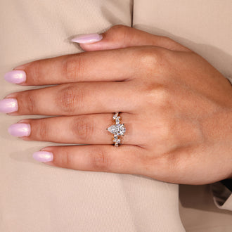 Handmade jewelry with a pear cut engagement ring centerpiece.
