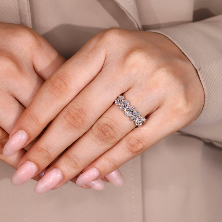 Handmade wedding band with oval diamonds and shared prongs.