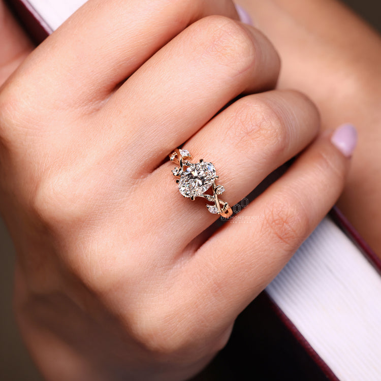 Nature inspired engagement ring with oval center and side accents
