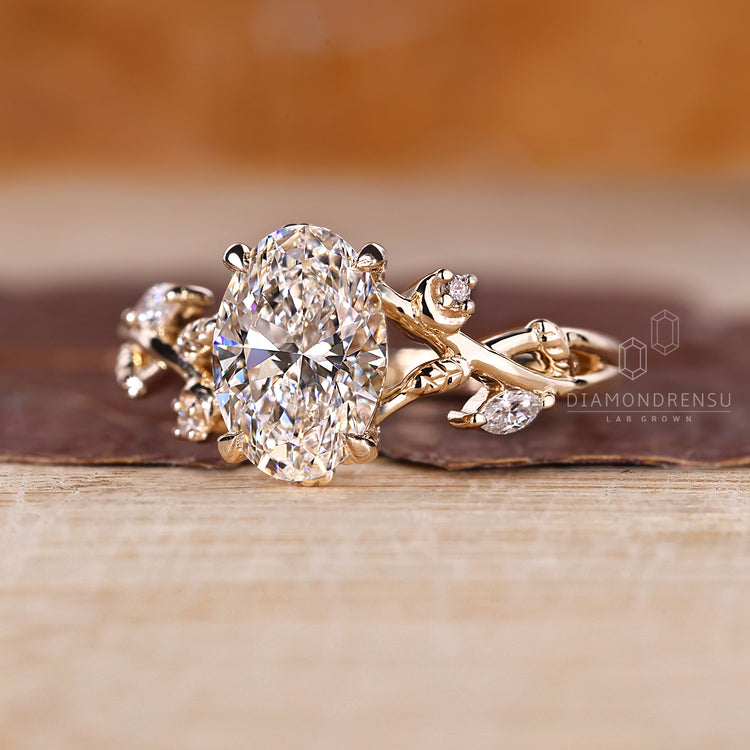Custom yellow gold engagement ring with oval and marquise diamonds
