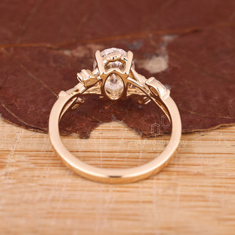 Yellow gold nature inspired engagement ring with oval cluster
