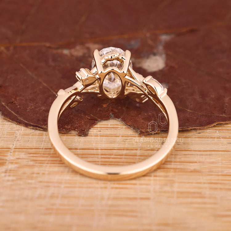 Yellow gold nature inspired engagement ring with oval cluster
