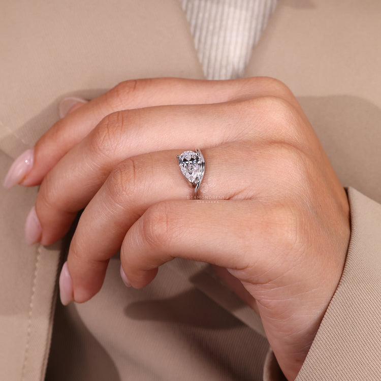 Handmade pear solitaire ring featuring 2 round prongs and V shaped design.
