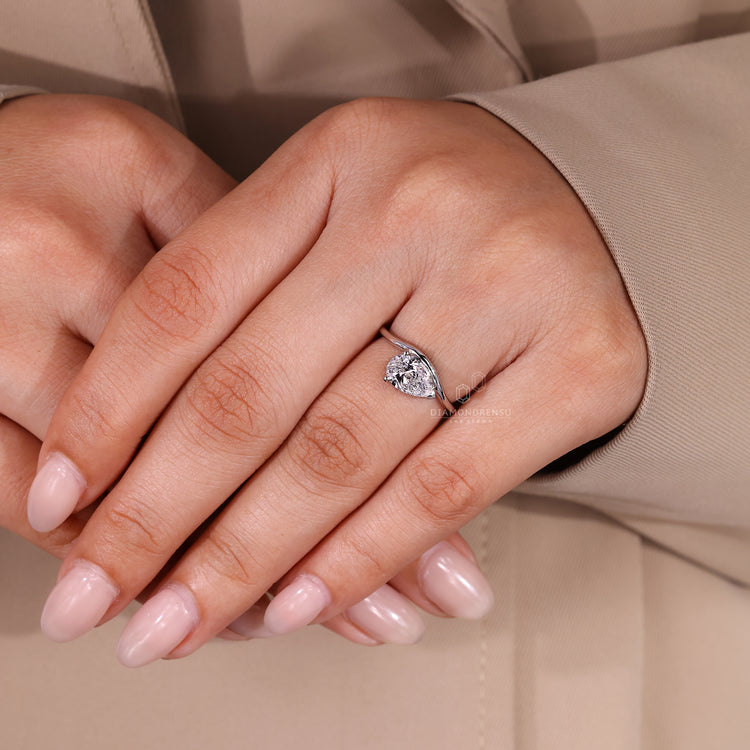 Custom engagement ring featuring pear solitaire and lab grown diamond.
