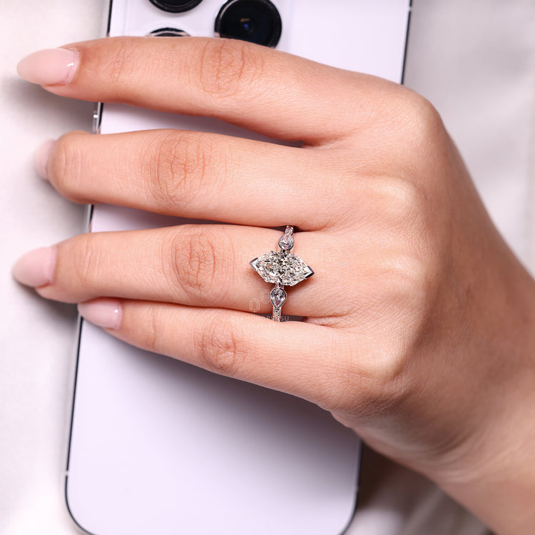 Art deco engagement ring with pear side stones and euro shank style.
