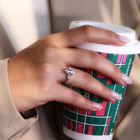 Six claw prong setting securing the center stone with elegance.
