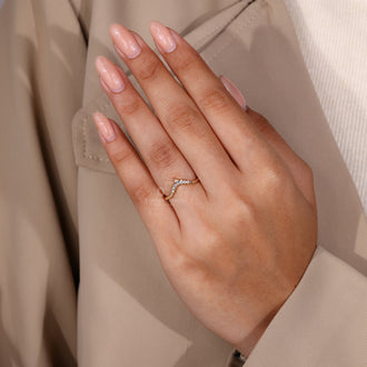 Classic yellow gold diamond band shimmering in natural light.
