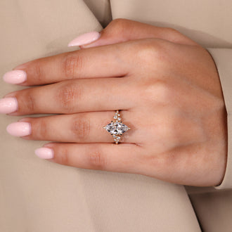 Handmade jewelry with marquise and round diamond side stones in a cluster setting with IGI certified diamond.
