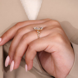 6 claw prong setting with marquise and round diamond side stones in a diamond ring and handmade jewelry design.
