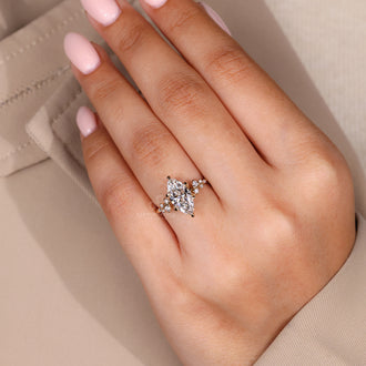 Marquise and round diamond set in a diamond ring with lab grown diamond and IGI certified design in a handmade ring.
