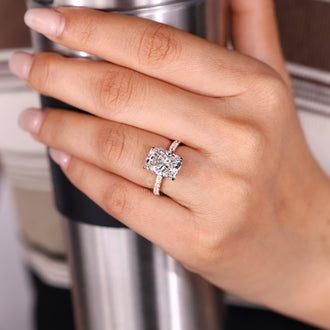 Custom diamond ring featuring elongated cushion and pave setting.
