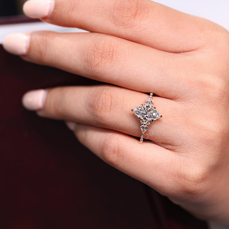 Kite and round side diamond ring paired with marquise engagement diamond.
